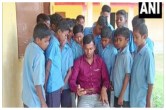 स्कूल में शिक्षक के मोबाइल पर एजुकेशन वीडियो देखते बच्चे