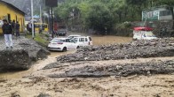 Vehicles stuck in the mud after a rain-triggered landslide in Ramban